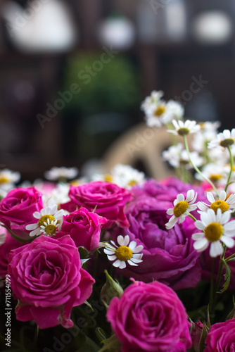 A bouquet of pink roses with daisies is a gift for women on March 8th or Valentine's Day