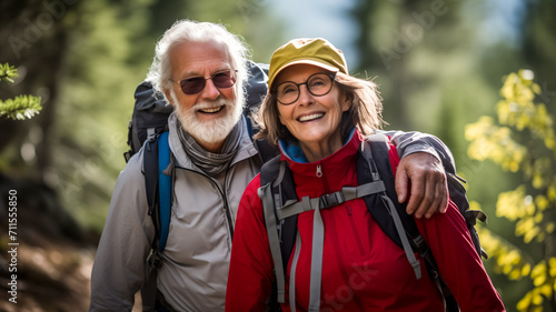 Senior couple hiking in nature with backpacks and smiles