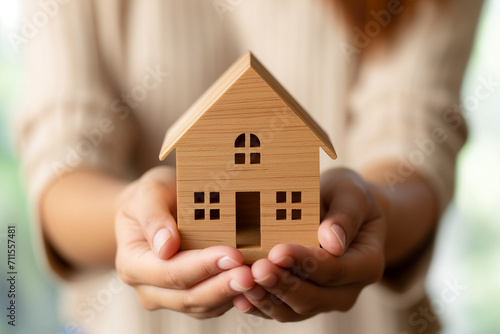 Financial Planning and Real Estate Investment, Businesswoman Holding Wooden House Model
