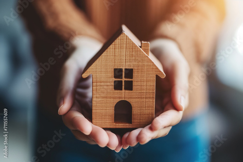 Financial Planning and Real Estate Investment, Businesswoman Holding Wooden House Model