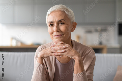Portrait of confident european senior lady with stylish haircut indoor photo