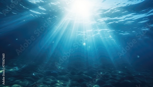 Blue ocean underwater with sunrays reaching background