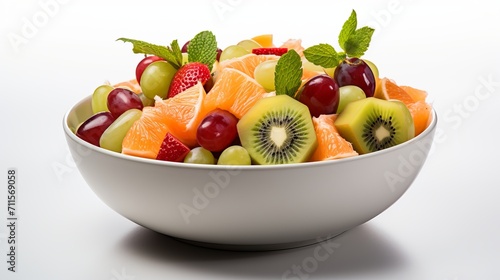 Colorful and nutritious fruit salad in a bowl, top view, isolated on white background