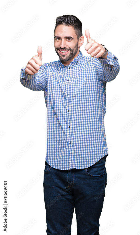 Young handsome man over isolated background approving doing positive gesture with hand, thumbs up smiling and happy for success. Looking at the camera, winner gesture. Young handsome man over isolated background approving doing positive gesture with hand, thumbs up smiling and happy for success. Looking at the camera, winner gesture.