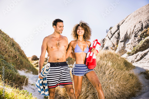 Mixed race couple having fun playing on the beach. Cape Town, South Africa