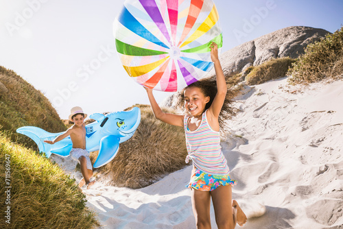 Mixed race family having fun playing on the beach. Cape Town, South Africa