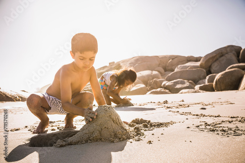 Mixed race family having fun playing on the beach. Cape Town, South Africa photo