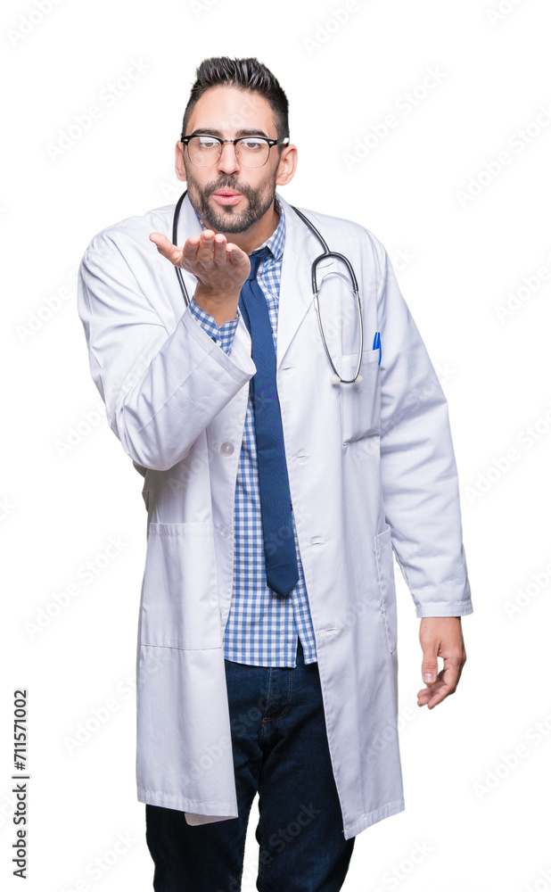 Handsome young doctor man over isolated background looking at the camera blowing a kiss with hand on air being lovely and sexy. Love expression. Handsome young doctor man over isolated background looking at the camera blowing a kiss with hand on air being lovely and sexy. Love expression.