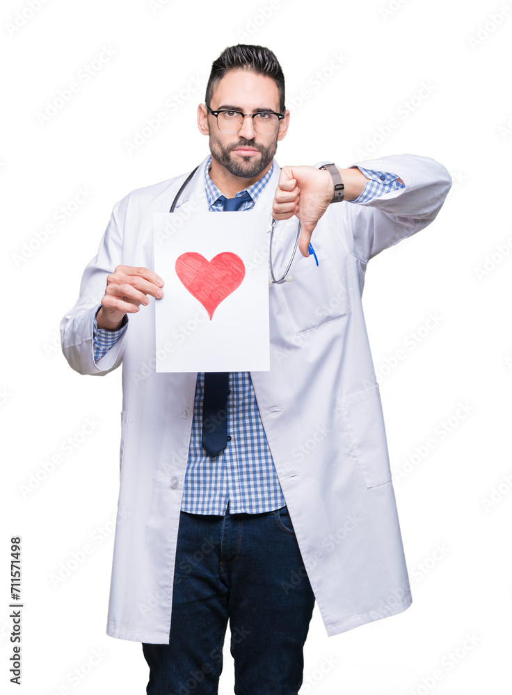 Handsome young doctor man holding paper with red heart over isolated background with angry face, negative sign showing dislike with thumbs down, rejection concept Handsome young doctor man holding paper with red heart over isolated background with angry face, negative sign showing dislike with thumbs down, rejection concept