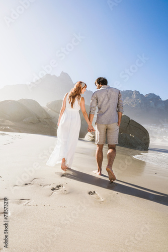 Couple getting married on the beach, boho style wedding, with loads of romance. Cape Town, South Africa photo