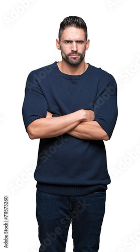 Young handsome man wearing sweater over isolated background skeptic and nervous, disapproving expression on face with crossed arms. Negative person.