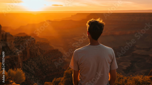 Man looking into a vast canyon with his back turned generative ai © ThisDesign