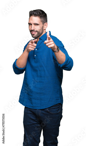 Young handsome man over isolated background pointing fingers to camera with happy and funny face. Good energy and vibes.