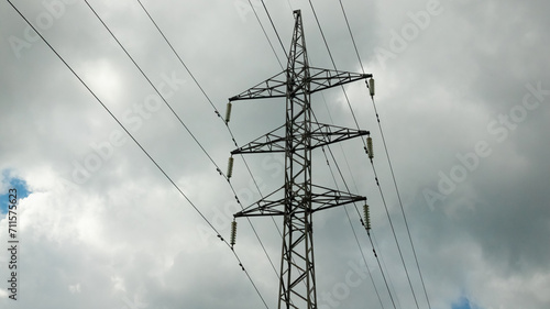 Power line pylon against the background of the dark cloudy sky