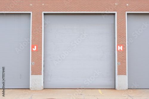 Large industrial loading dock doors on brick warehouse