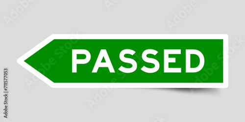 Green color arrow shape sticker label with word passed on gray background
