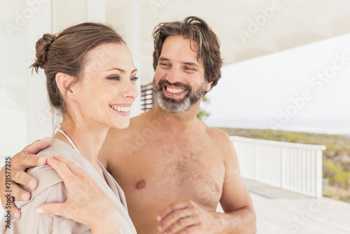 Middle aged couple arm in arm enjoying a spa day. Grotto Bay, South Africa photo