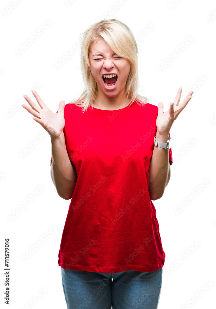 Young beautiful blonde woman wearing red t-shirt over isolated background celebrating mad and crazy for success with arms raised and closed eyes screaming excited. Winner concept Young beautiful blonde woman wearing red t-shirt over isolated background celebrating mad and crazy for success with arms raised and closed eyes screaming excited. Winner concept