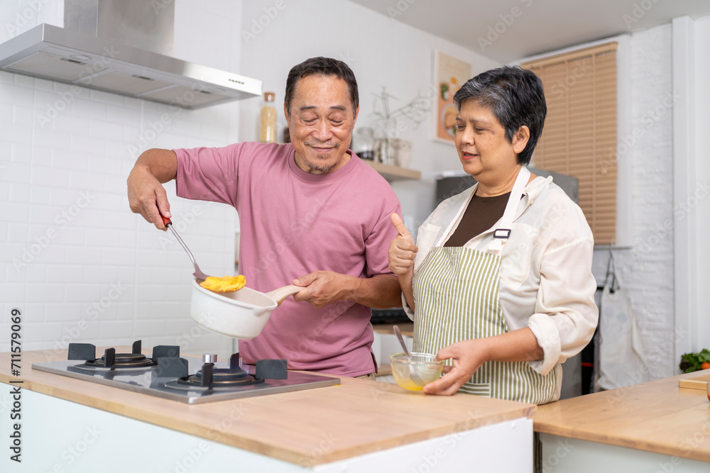 Mature asian Couples enjoy to cooking meal together in kitchen. Mature asian Couples enjoy to cooking meal together in kitchen.