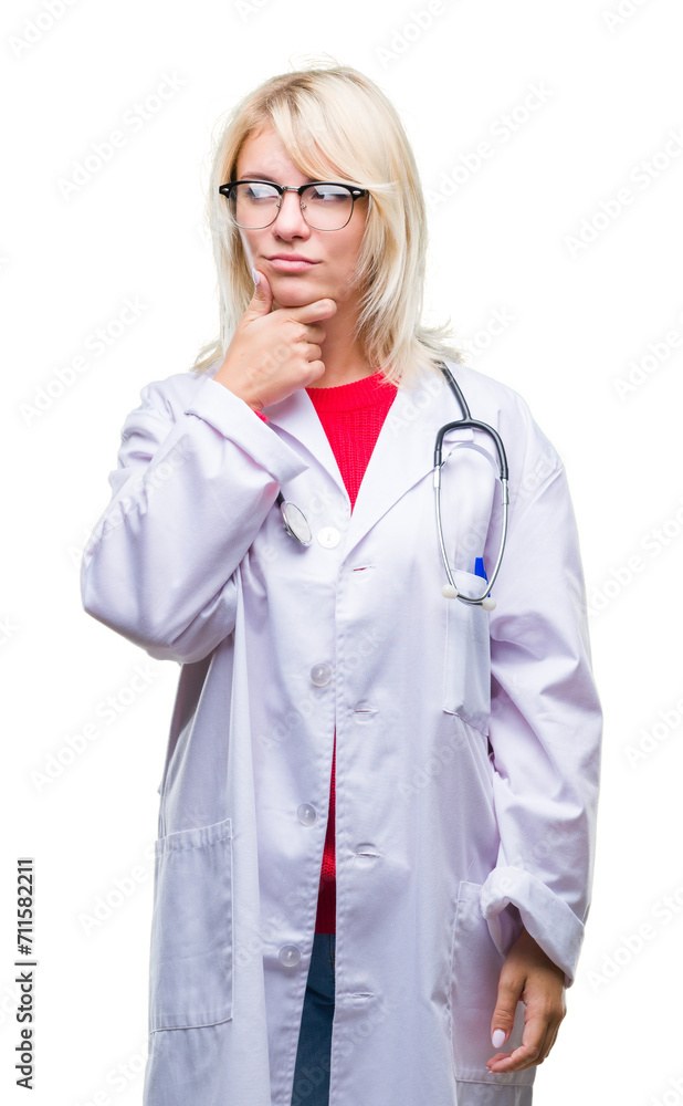 Young beautiful blonde doctor woman wearing medical uniform over isolated background with hand on chin thinking about question, pensive expression. Smiling with thoughtful face. Doubt concept. Young beautiful blonde doctor woman wearing medical uniform over isolated background with hand on chin thinking about question, pensive expression. Smiling with thoughtful face. Doubt concept.