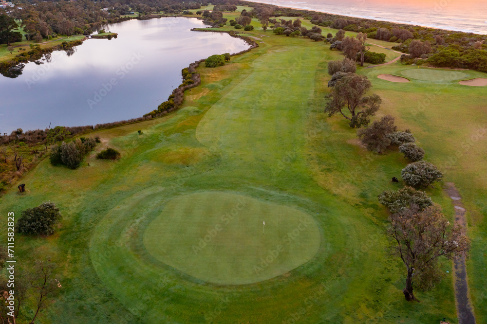 Aerial view over a coastal golf course during a colourful sunrise Aerial view over a coastal golf course during a colourful sunrise