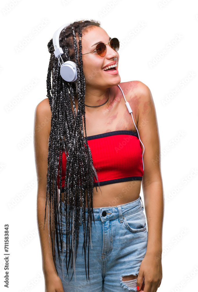 Young braided hair african american with birth mark wearing headphones over isolated background looking away to side with smile on face, natural expression. Laughing confident. Young braided hair african american with birth mark wearing headphones over isolated background looking away to side with smile on face, natural expression. Laughing confident.