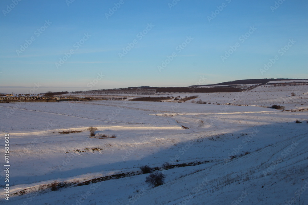 A snowy landscape with a blue sky A snowy landscape with a blue sky