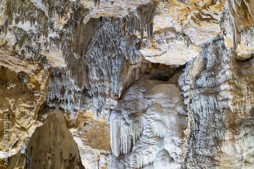 Lime stone stalactites in the cave - mineral formation that hangs from the cave's ceiling