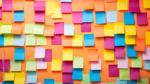 Many colorful  sticky notes  or adhesive notes on a wall or bulletin board.