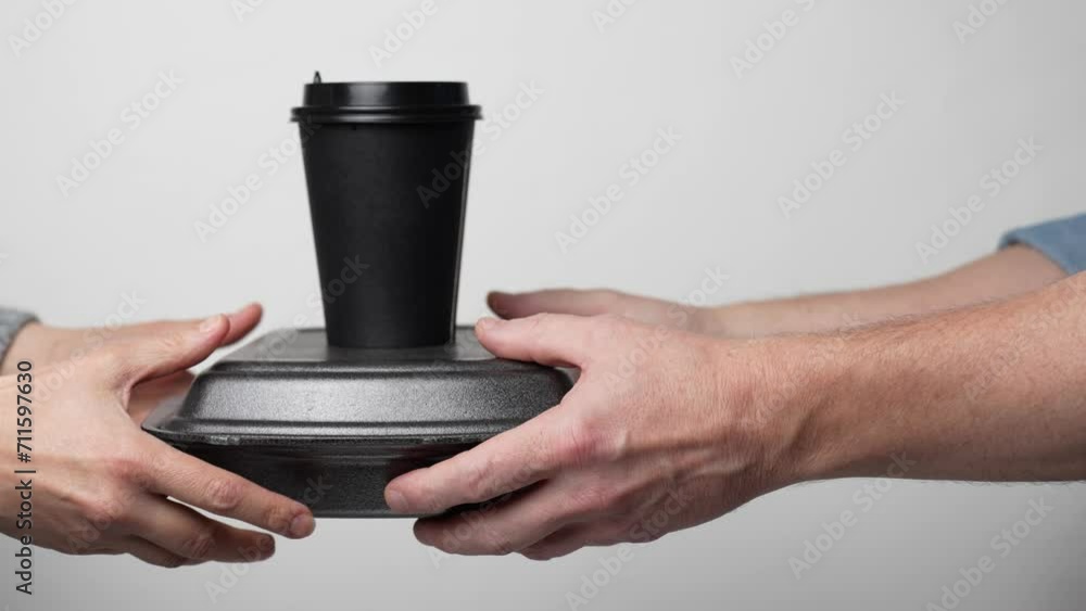 Hand give take away delivery food box container and coffee cup Hand give take away delivery food box container and coffee cup