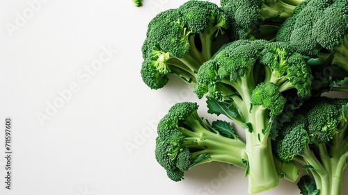 Bunch of green broccoli with fresh florets on a clean white surface