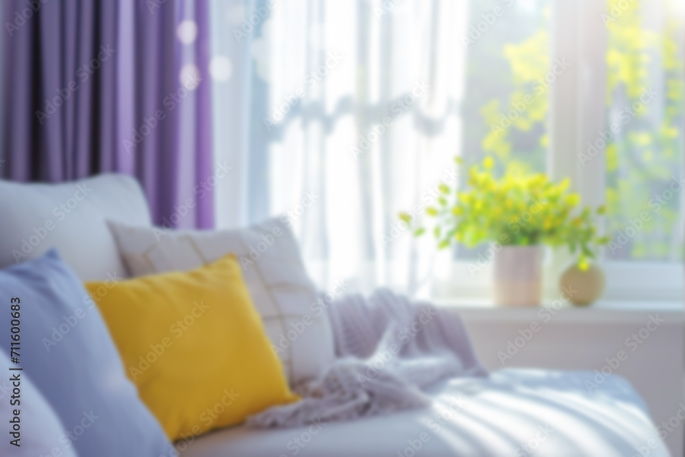 Blurred background of a cozy living room with sofa cushions and a large window