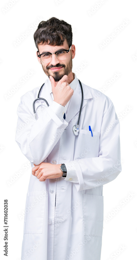 Young doctor man wearing hospital coat over isolated background looking confident at the camera with smile with crossed arms and hand raised on chin. Thinking positive. Young doctor man wearing hospital coat over isolated background looking confident at the camera with smile with crossed arms and hand raised on chin. Thinking positive.