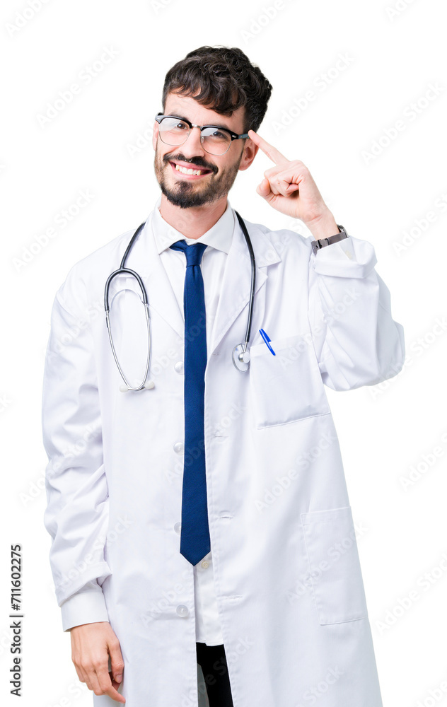 Young doctor man wearing hospital coat over isolated background Smiling pointing to head with one finger, great idea or thought, good memory Young doctor man wearing hospital coat over isolated background Smiling pointing to head with one finger, great idea or thought, good memory