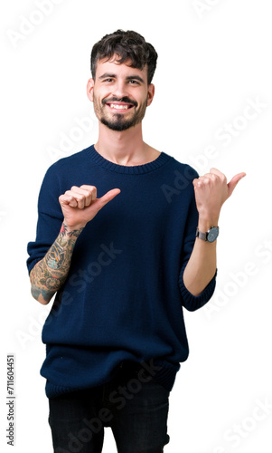 Young handsome man over isolated background Pointing to the back behind with hand and thumbs up, smiling confident photo