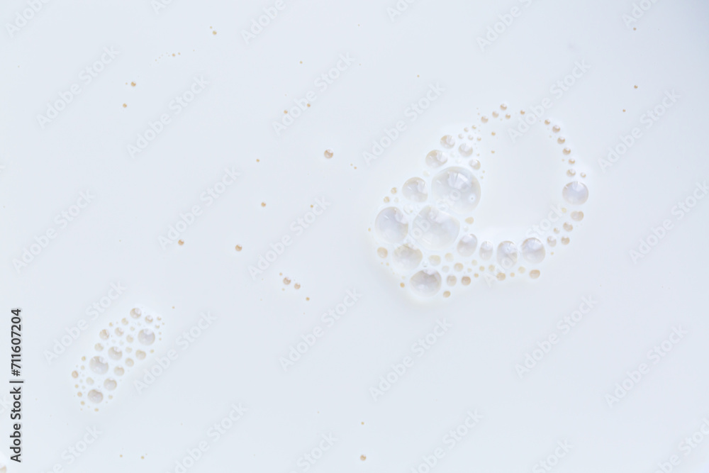 Fototapeta premium Macro milk texture,White surface of milk and bubbles and ripples from above birds eye view