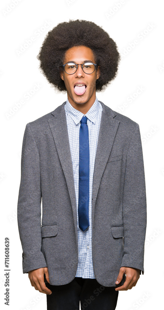 Young african american business man with afro hair wearing glasses sticking tongue out happy with funny expression. Emotion concept. Young african american business man with afro hair wearing glasses sticking tongue out happy with funny expression. Emotion concept.