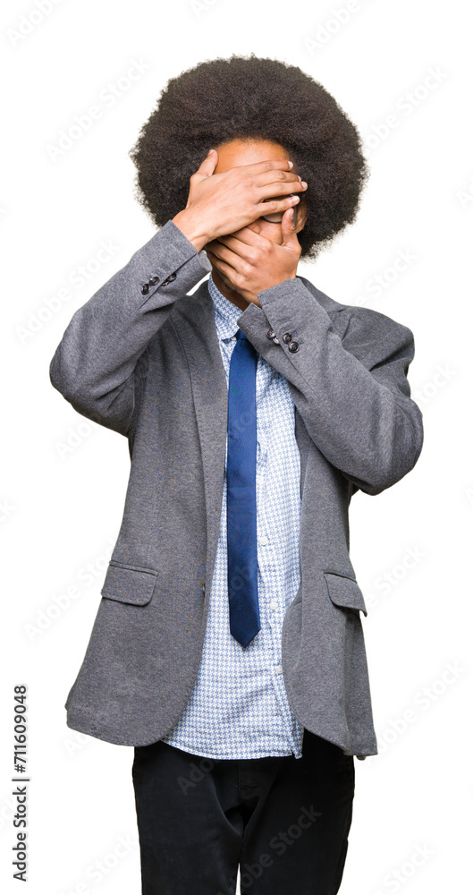 Young african american business man with afro hair wearing glasses Covering eyes and mouth with hands, surprised and shocked. Hiding emotion Young african american business man with afro hair wearing glasses Covering eyes and mouth with hands, surprised and shocked. Hiding emotion