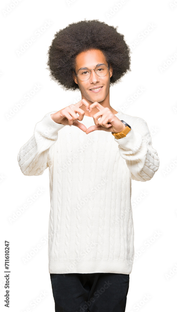 Young african american man with afro hair wearing glasses smiling in love showing heart symbol and shape with hands. Romantic concept. Young african american man with afro hair wearing glasses smiling in love showing heart symbol and shape with hands. Romantic concept.