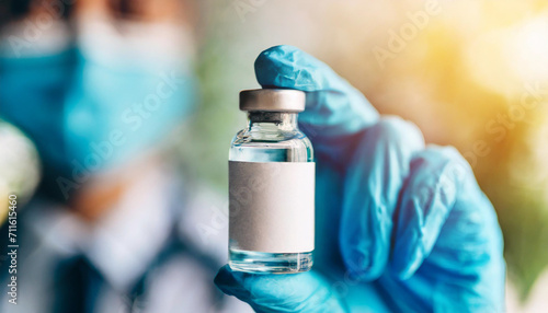 Hand in medical glove holds a vaccine vial, symbolizing hope and protection against infectious diseases