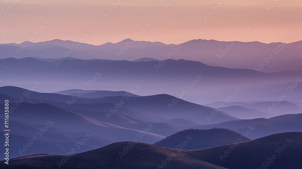 Landscape with blue misty silhouettes of mountains at sunrise
