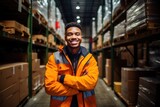 a smiling warehouse worker standing near large shelves full of racking