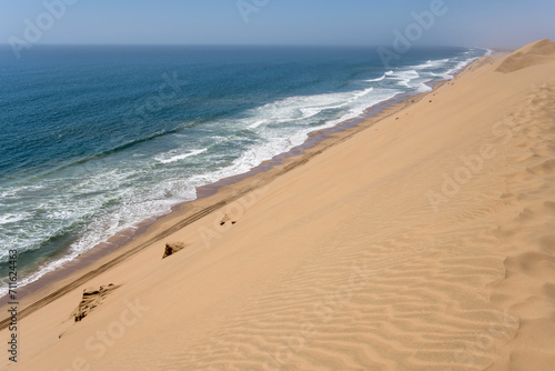 shore with dune slope and Atlantic waves from above at Sandwich Harbour, Namibia