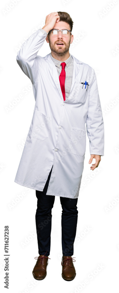Young handsome scientist man wearing glasses surprised with hand on head for mistake, remember error. Forgot, bad memory concept. Young handsome scientist man wearing glasses surprised with hand on head for mistake, remember error. Forgot, bad memory concept.