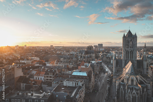 Watching the sunset over Ghent from the historic tower in the city centre. Romantic colours in the sky. Red light illuminating Ghent, Flanders region, Belgium