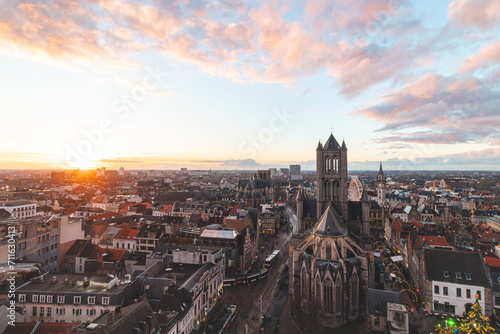 Watching the sunset over Ghent from the historic tower in the city centre. Romantic colours in the sky. Red light illuminating Ghent, Flanders region, Belgium