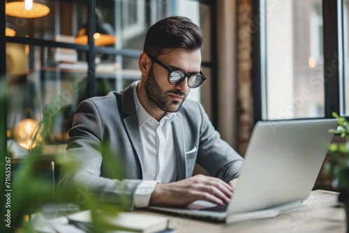 Diligent Businessman Engrossed In Laptop, Fully Engaged In Office Work