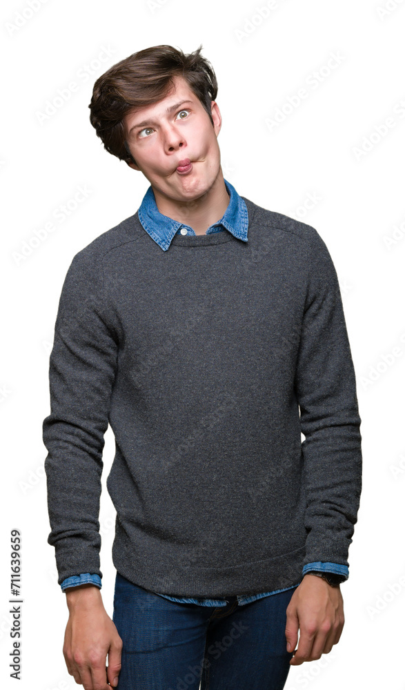 Fototapeta premium Young handsome elegant man over isolated background making fish face with lips, crazy and comical gesture. Funny expression.