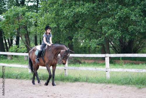 Teenage girl riding a horse