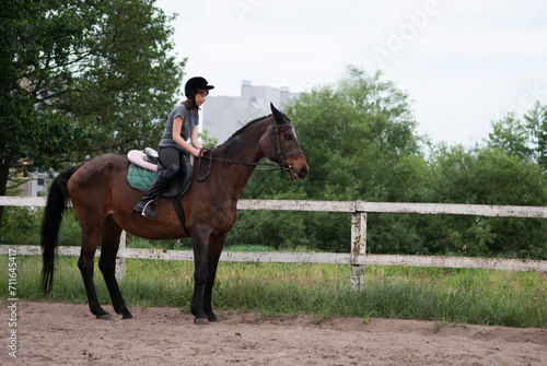 Teenage girl riding a horse © iredman